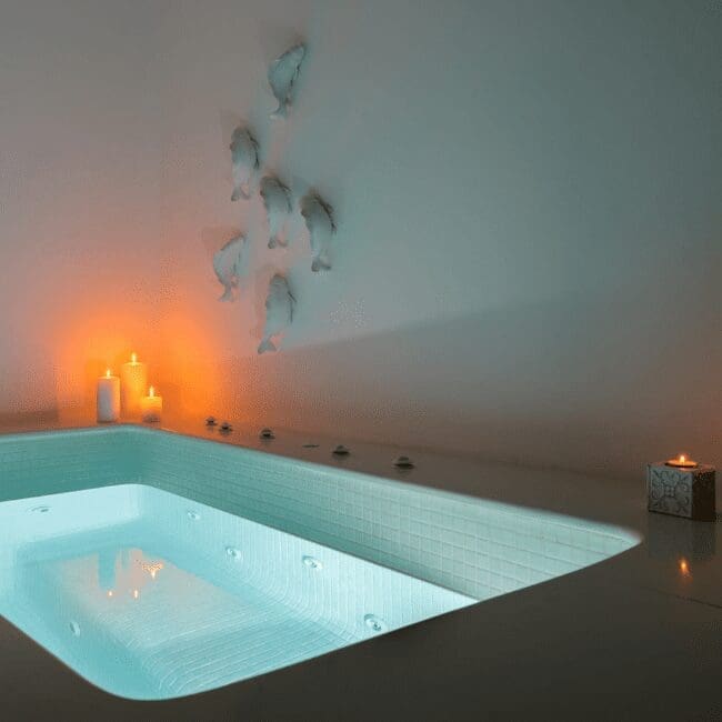 Indoor hot tub with mosaic tiling and candlelight in the Suite with Indoor Hot Tub