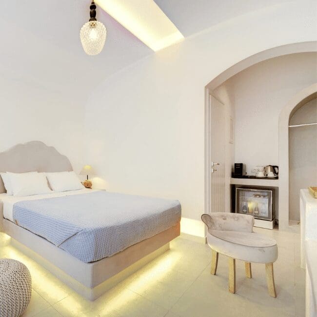 Suite with Indoor Hot Tub bedroom with an arched alcove and warm accent lighting