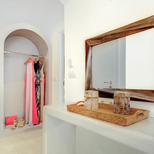 Dressing area with an arched wardrobe and rustic mirror in the Suite with Indoor Hot Tub