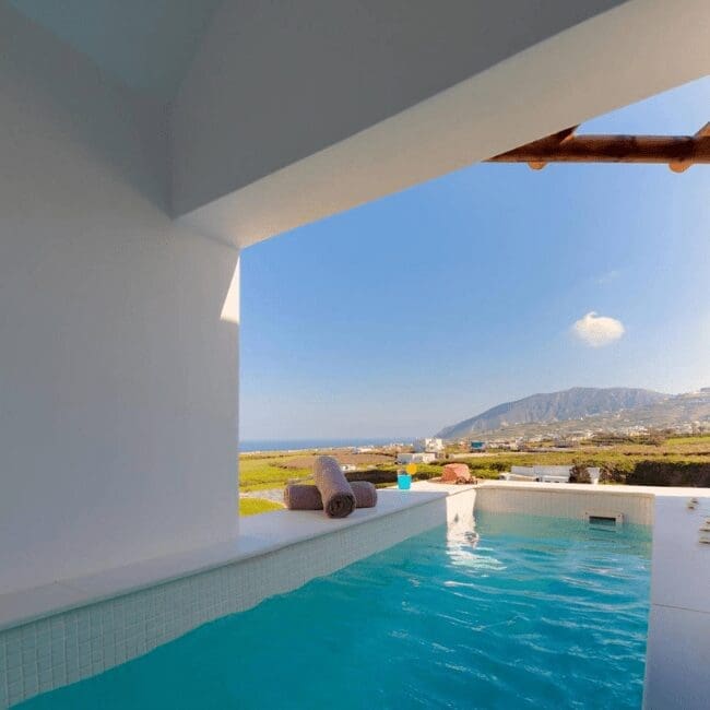 Private terrace plunge pool overlooking the Santorini countryside and sea at Emerald Collection Suites
