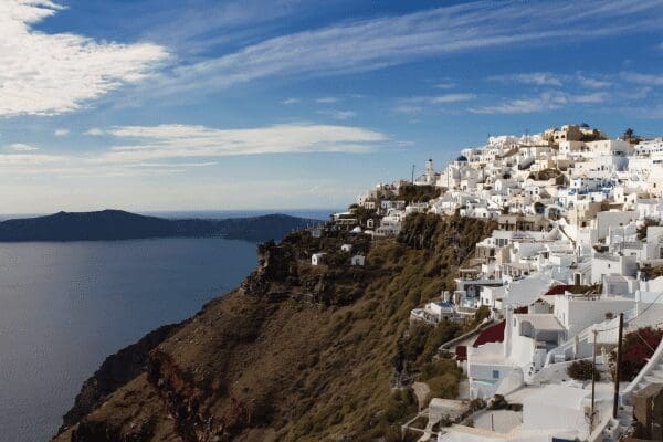 Whitewashed Imerovigli village perched on the caldera cliff edge, Santorini