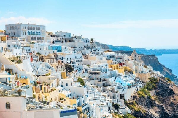 Fira town white buildings cascading down the caldera cliff, Santorini